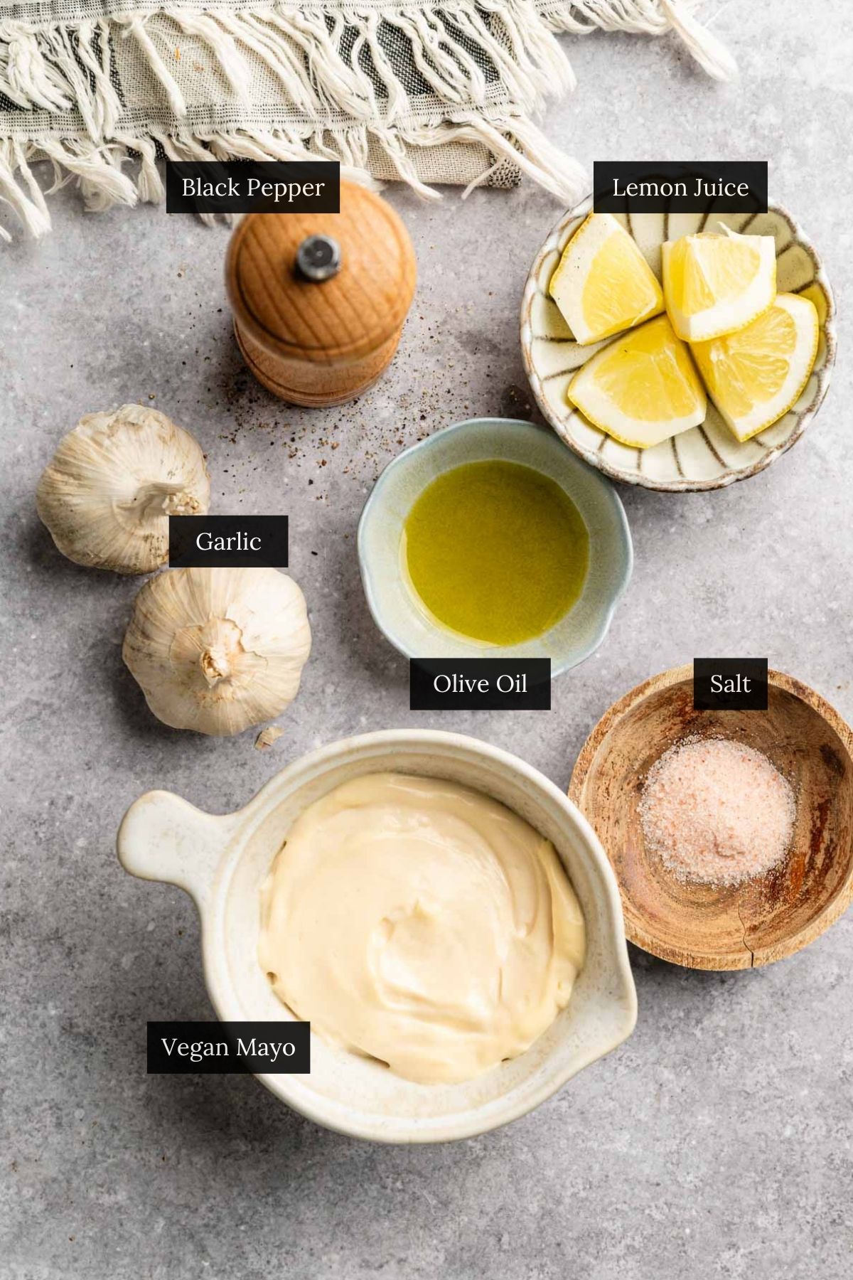 Ingredients for homemade roasted garlic sauce with each ingredient labeled.