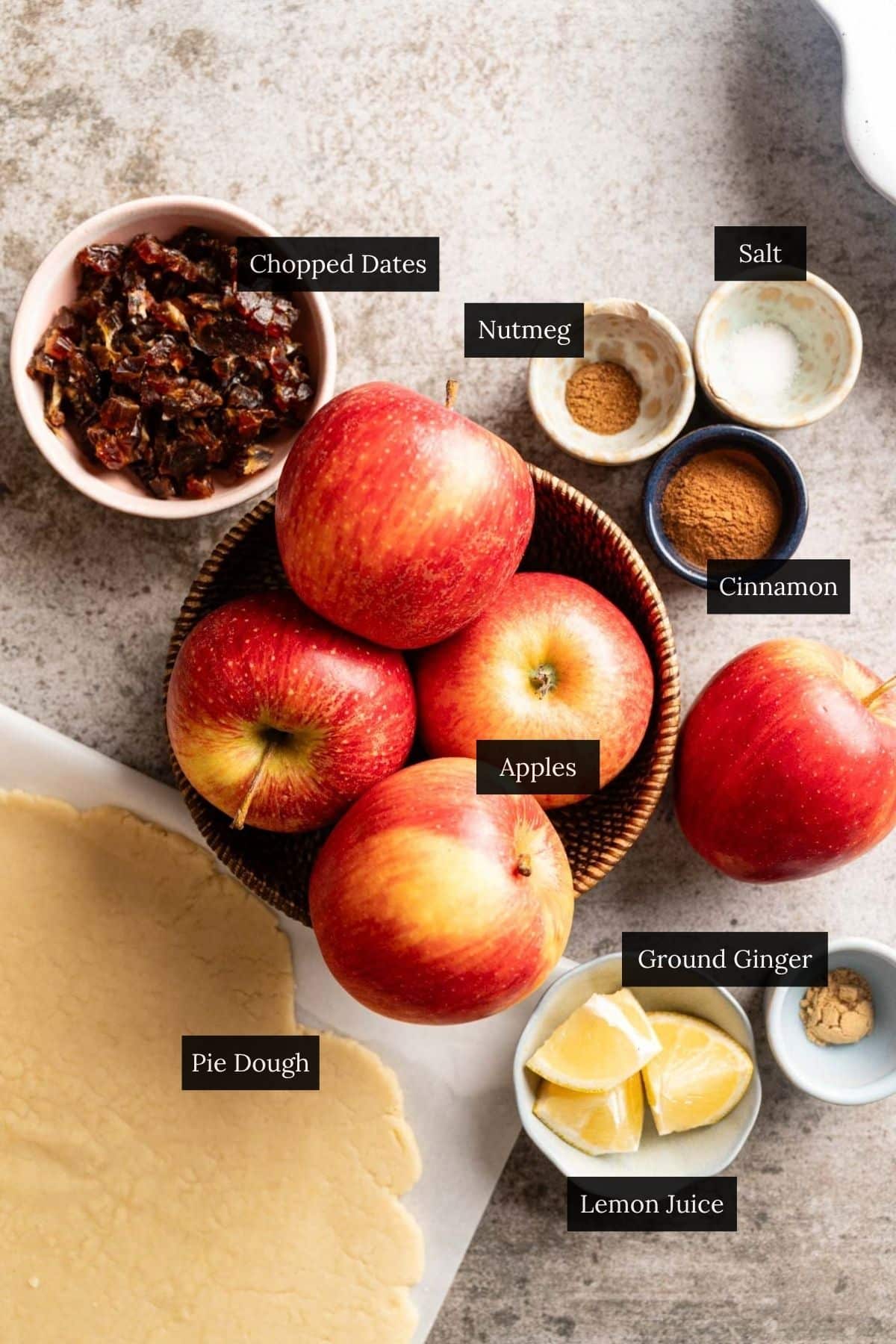 Ingredients for sugar free vegan apple pie with each ingredient labeled.