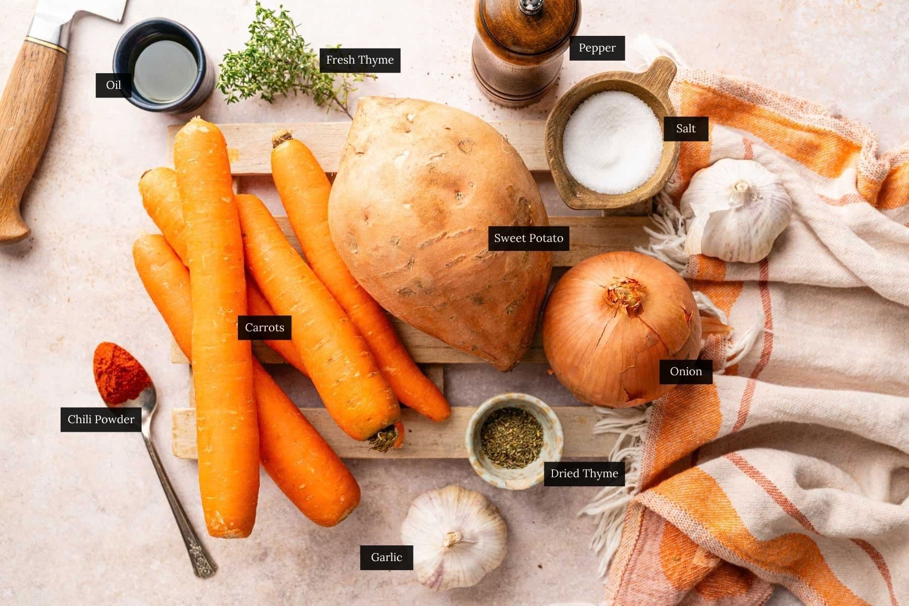 All the ingredients you need for baking these carrots and sweet potatoes with each ingredient labeled.