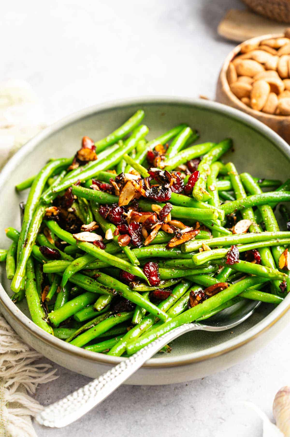 Close up of cranberries, almonds, and green beans.