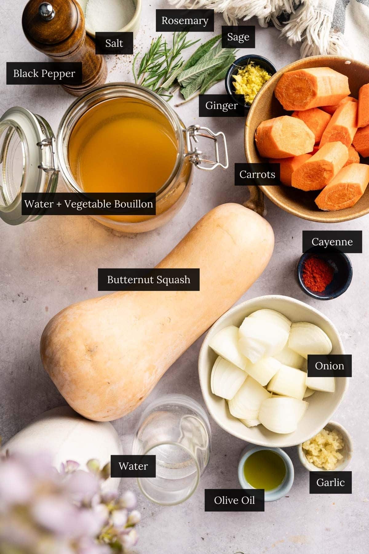 Ingredients for carrot butternut squash soup with each ingredient labeled.